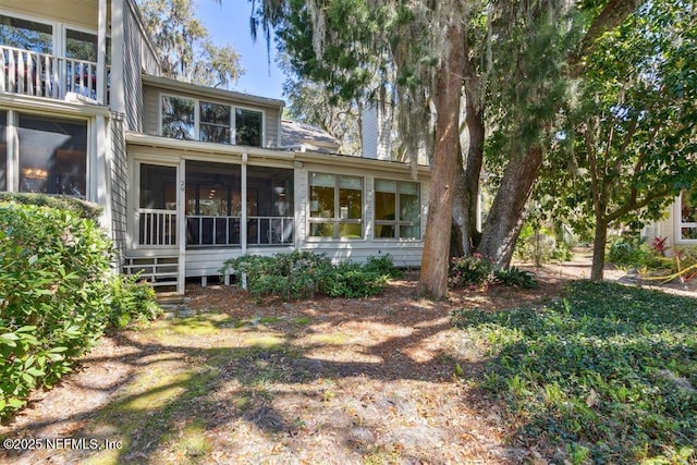 3429 Sea Marsh Rd, Fernandina Beach, FL 32034 - back of house featuring a sunroom and a chimney