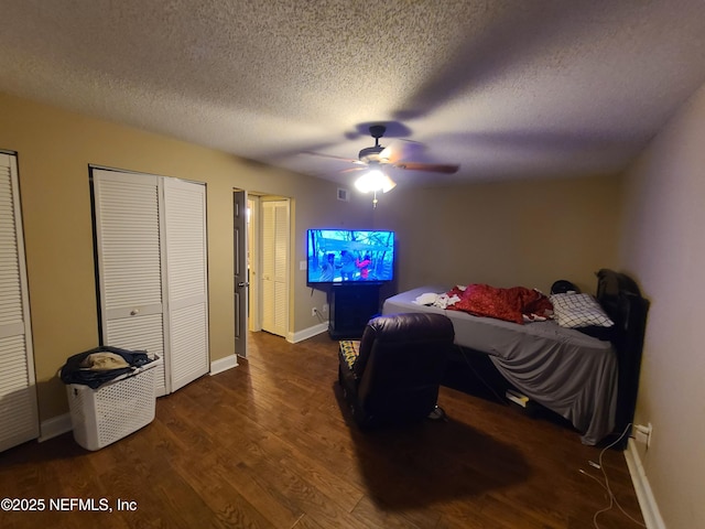 8741 Whispering Pines Dr, Jacksonville, FL 32244 - bedroom with wood finished floors, baseboards, a textured ceiling, and multiple closets