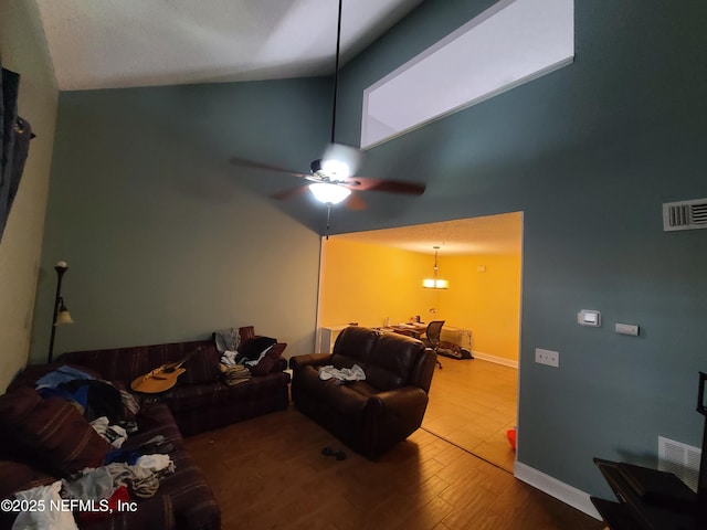 8741 Whispering Pines Dr, Jacksonville, FL 32244 - living area with wood finished floors, high vaulted ceiling, ceiling fan, and baseboards