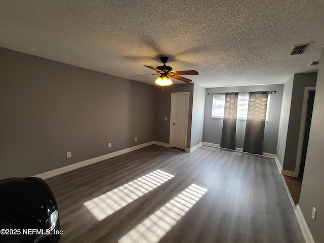 8741 Whispering Pines Dr, Jacksonville, FL 32244 - unfurnished bedroom featuring wood finished floors, a textured ceiling, baseboards, and a ceiling fan