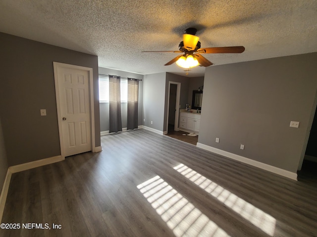 8741 Whispering Pines Dr, Jacksonville, FL 32244 - unfurnished bedroom featuring a textured ceiling, dark wood-style flooring, baseboards, ensuite bathroom, and ceiling fan