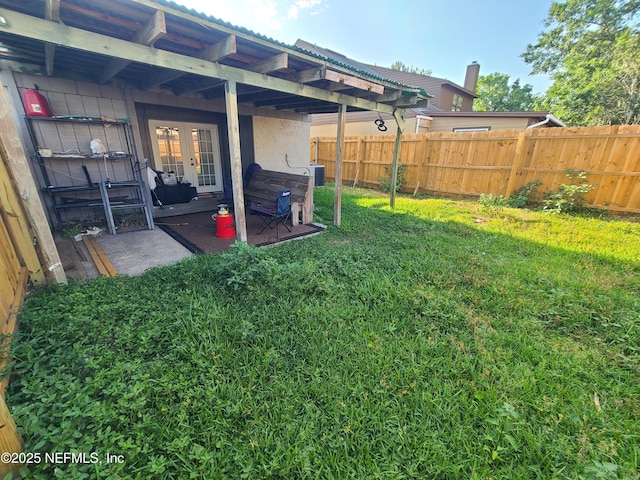 8741 Whispering Pines Dr, Jacksonville, FL 32244 - view of yard featuring french doors, central air condition unit, and a patio