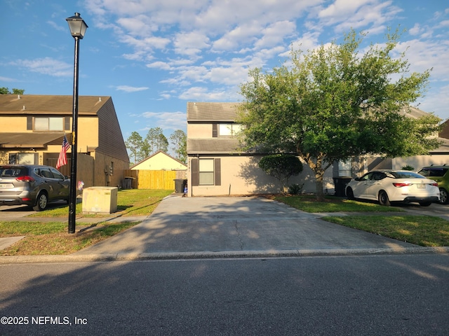 8741 Whispering Pines Dr, Jacksonville, FL 32244 - view of front facade featuring fence and stucco siding