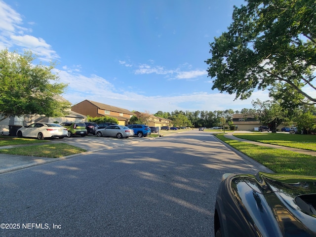 8741 Whispering Pines Dr, Jacksonville, FL 32244 - view of asphalt road featuring a residential view and sidewalks