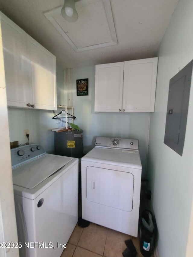 8741 Whispering Pines Dr, Jacksonville, FL 32244 - clothes washing area with washer and dryer, cabinet space, electric panel, light tile patterned floors, and water heater