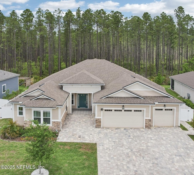 210 Terra Oaks Dr, Saint Johns, FL 32259 - view of front of home featuring stone siding, an attached garage, decorative driveway, and roof with shingles