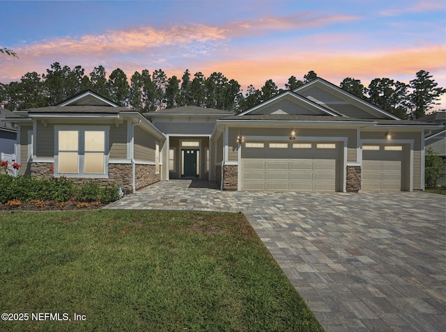 210 Terra Oaks Dr, Saint Johns, FL 32259 - view of front of house featuring stone siding, decorative driveway, a garage, and a lawn