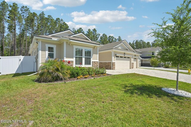 210 Terra Oaks Dr, Saint Johns, FL 32259 - view of front of property featuring driveway, stone siding, an attached garage, and a gate