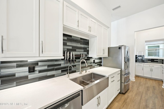 210 Terra Oaks Dr, Saint Johns, FL 32259 - kitchen with a sink, backsplash, white cabinetry, and stainless steel refrigerator with ice dispenser