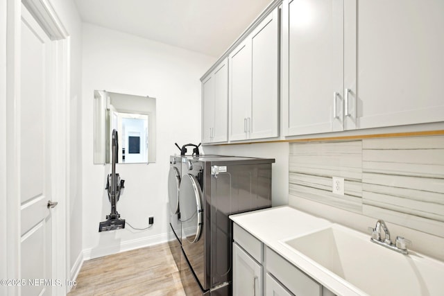 210 Terra Oaks Dr, Saint Johns, FL 32259 - laundry room featuring cabinet space, washing machine and dryer, light wood-style floors, and baseboards