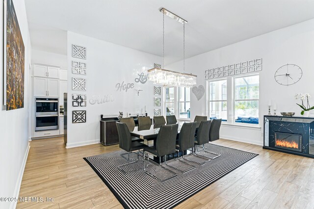 210 Terra Oaks Dr, Saint Johns, FL 32259 - dining space featuring light wood-style flooring and a glass covered fireplace