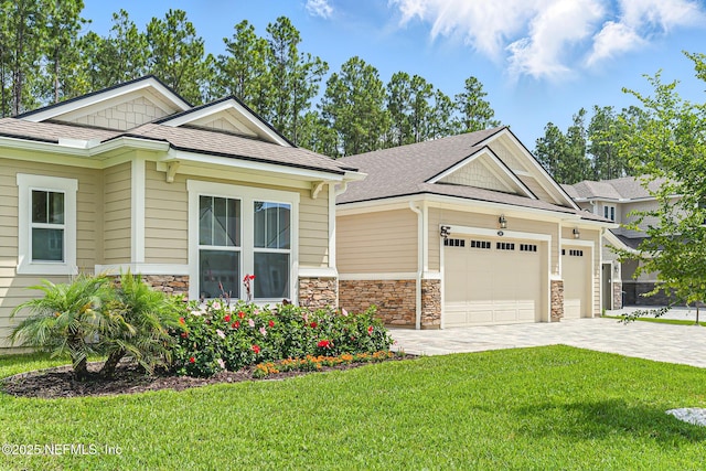 210 Terra Oaks Dr, Saint Johns, FL 32259 - craftsman house featuring stone siding, a front yard, decorative driveway, and a garage