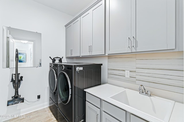 210 Terra Oaks Dr, Saint Johns, FL 32259 - laundry area featuring separate washer and dryer, cabinet space, and light wood-style flooring
