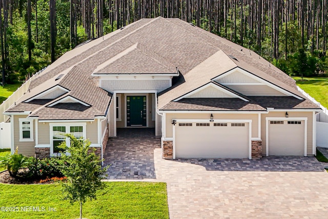 210 Terra Oaks Dr, Saint Johns, FL 32259 - view of front of property featuring stone siding, decorative driveway, an attached garage, and roof with shingles