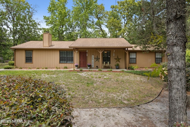 single story home featuring a porch, a chimney, and a shingled roof
