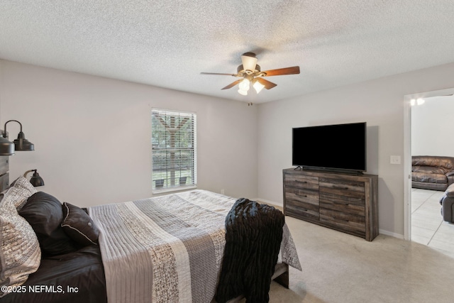 bedroom with carpet flooring, a ceiling fan, and a textured ceiling