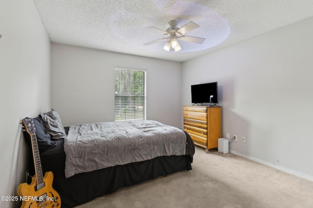 bedroom with carpet, a textured ceiling, and a ceiling fan