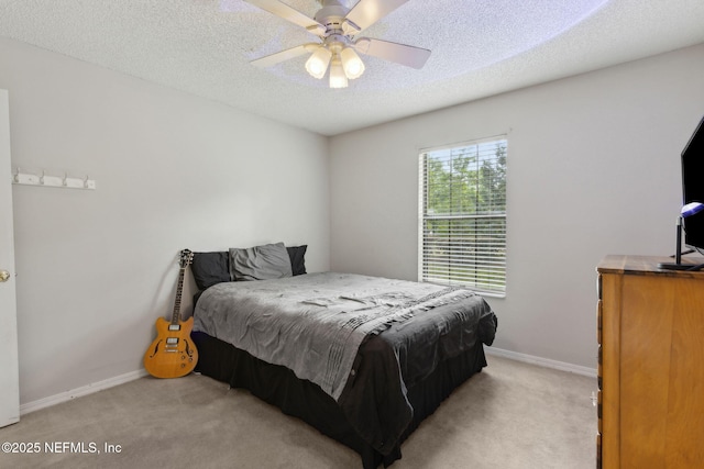 bedroom with light carpet, baseboards, a textured ceiling, and ceiling fan