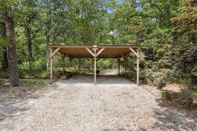 view of property's community featuring a detached carport and driveway