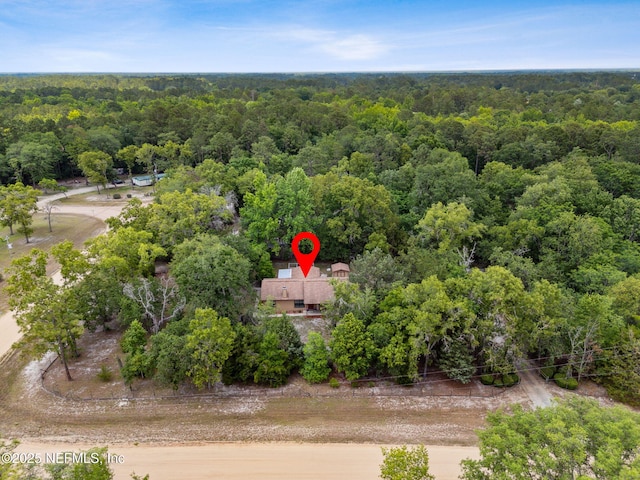 view from above of property featuring a heavily wooded area