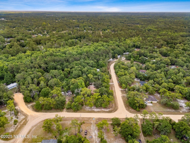 view of property location featuring a heavily wooded area