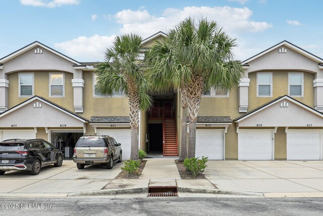 607 Golden Lake Loop, Saint Augustine, FL 32084 - view of property with a garage, stucco siding, and driveway