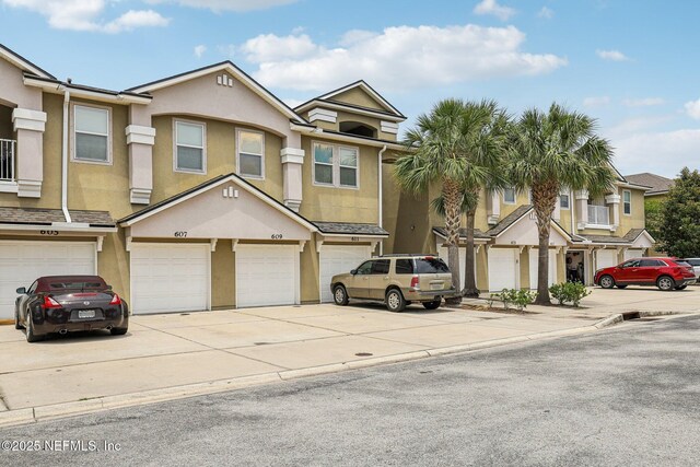 607 Golden Lake Loop, Saint Augustine, FL 32084 - view of property featuring stucco siding, driveway, and a garage