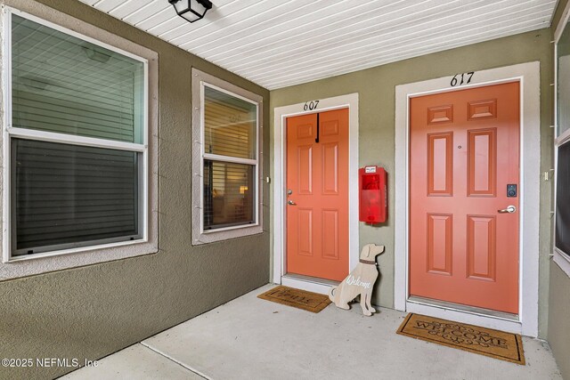 607 Golden Lake Loop, Saint Augustine, FL 32084 - doorway to property with covered porch and stucco siding