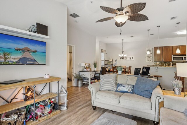 607 Golden Lake Loop, Saint Augustine, FL 32084 - living area with light wood finished floors, a ceiling fan, and a chandelier