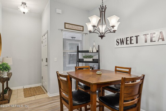 607 Golden Lake Loop, Saint Augustine, FL 32084 - dining area with a chandelier, light wood finished floors, and baseboards