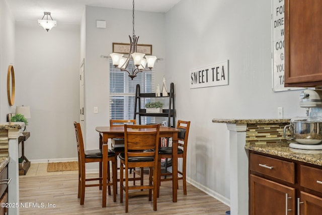 607 Golden Lake Loop, Saint Augustine, FL 32084 - dining space with light wood-style flooring, a chandelier, and baseboards