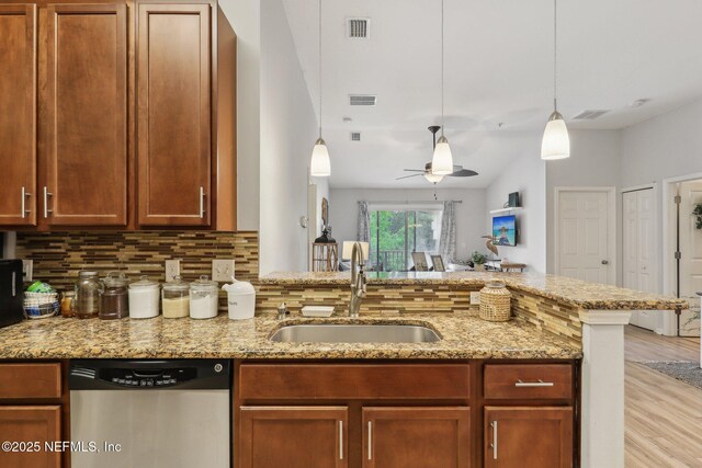 607 Golden Lake Loop, Saint Augustine, FL 32084 - kitchen with stainless steel dishwasher, a sink, backsplash, a ceiling fan, and light wood-type flooring