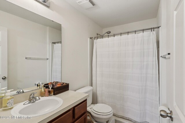 607 Golden Lake Loop, Saint Augustine, FL 32084 - bathroom featuring toilet, vanity, and a shower with shower curtain