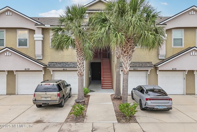 607 Golden Lake Loop, Saint Augustine, FL 32084 - townhome / multi-family property featuring an attached garage, stucco siding, and driveway