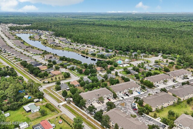 607 Golden Lake Loop, Saint Augustine, FL 32084 - aerial view of property and surrounding area featuring a heavily wooded area, nearby suburban area, and a large body of water