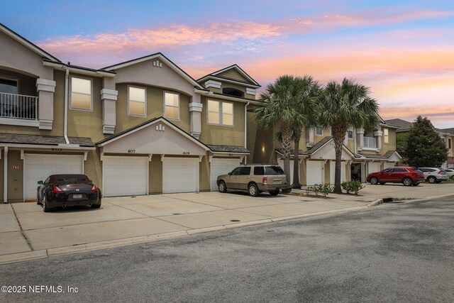607 Golden Lake Loop, Saint Augustine, FL 32084 - multi unit property with stucco siding, driveway, and an attached garage