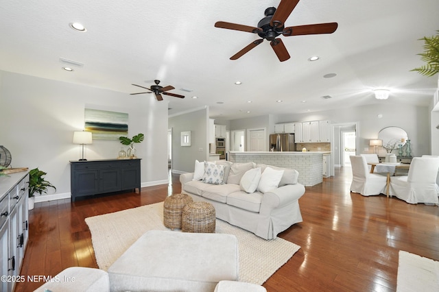 living room with ceiling fan, baseboards, dark wood finished floors, and recessed lighting