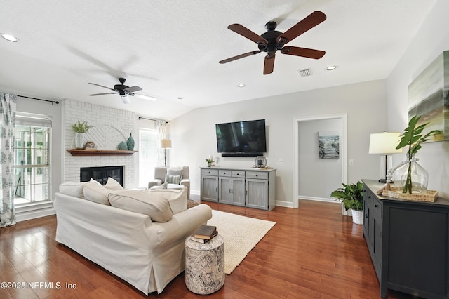 living room with ceiling fan, healthy amount of natural light, wood finished floors, a fireplace, and recessed lighting