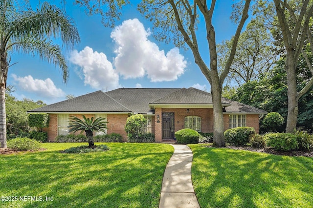 view of front of home featuring a front yard and brick siding