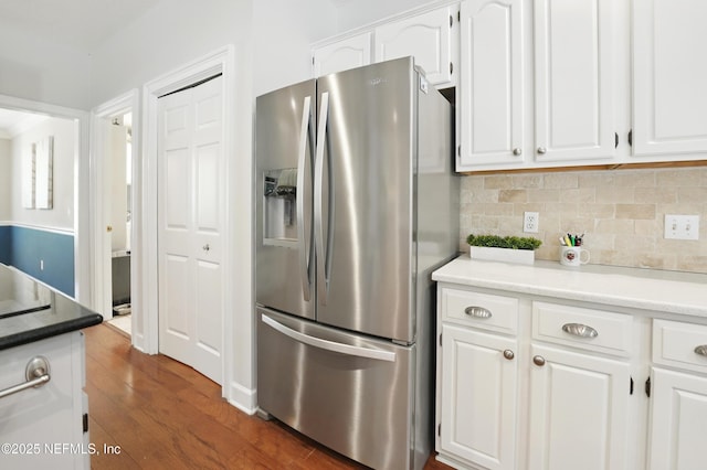 kitchen featuring stainless steel fridge, dark wood-style floors, and white cabinetry