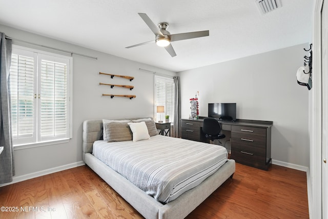 bedroom with baseboards, wood finished floors, a desk, and ceiling fan