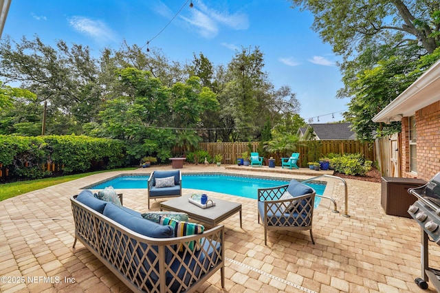view of swimming pool with outdoor lounge area, a fenced backyard, and a patio