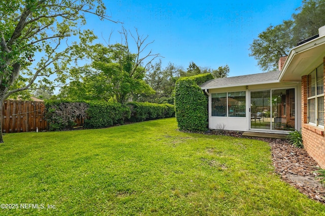view of yard featuring a sunroom