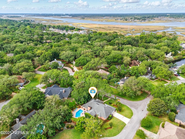 aerial view of property and surrounding area with a large body of water and nearby suburban area