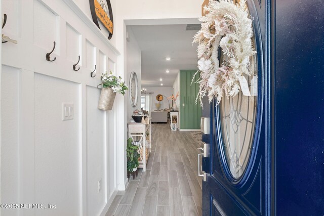 foyer entrance featuring wood finished floors, recessed lighting, and baseboards