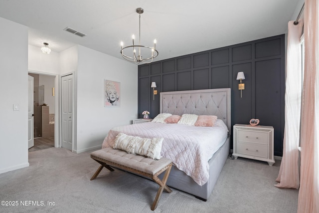 bedroom featuring a chandelier, light carpet, a decorative wall, baseboards, and connected bathroom