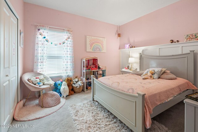 bedroom with carpet and a closet