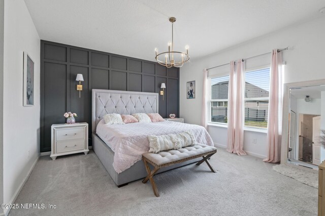 bedroom featuring light carpet, a chandelier, and baseboards