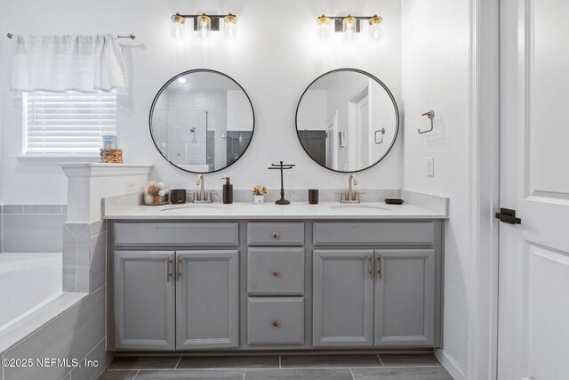 full bathroom featuring double vanity and a bath