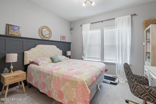 bedroom featuring carpet and vaulted ceiling